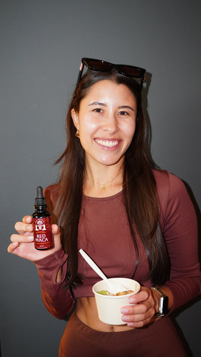 Woman showcasing Munay Botanicals natural herbal wellness product with a healthy lifestyle.
