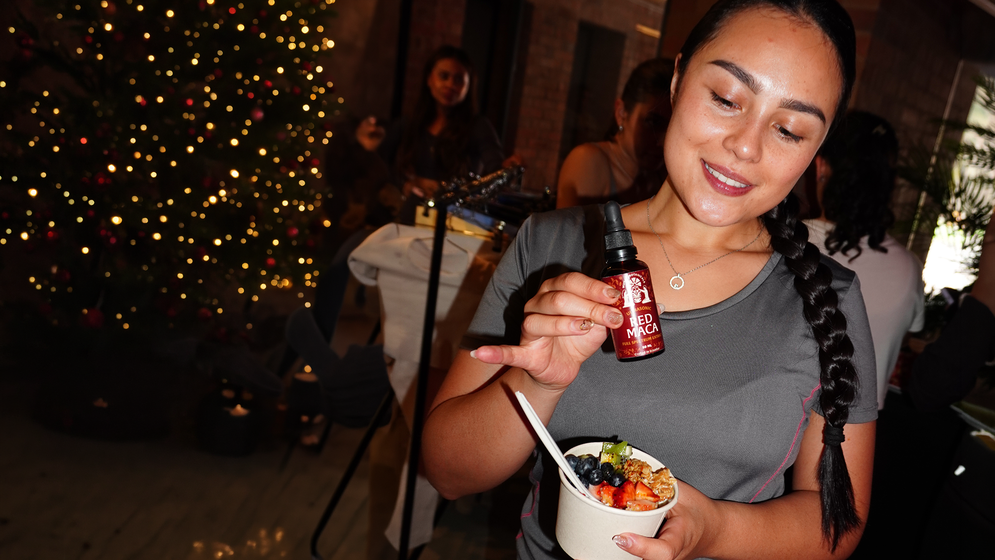 Person enjoying a Munay Botanicals herbal extract in a relaxed setting.